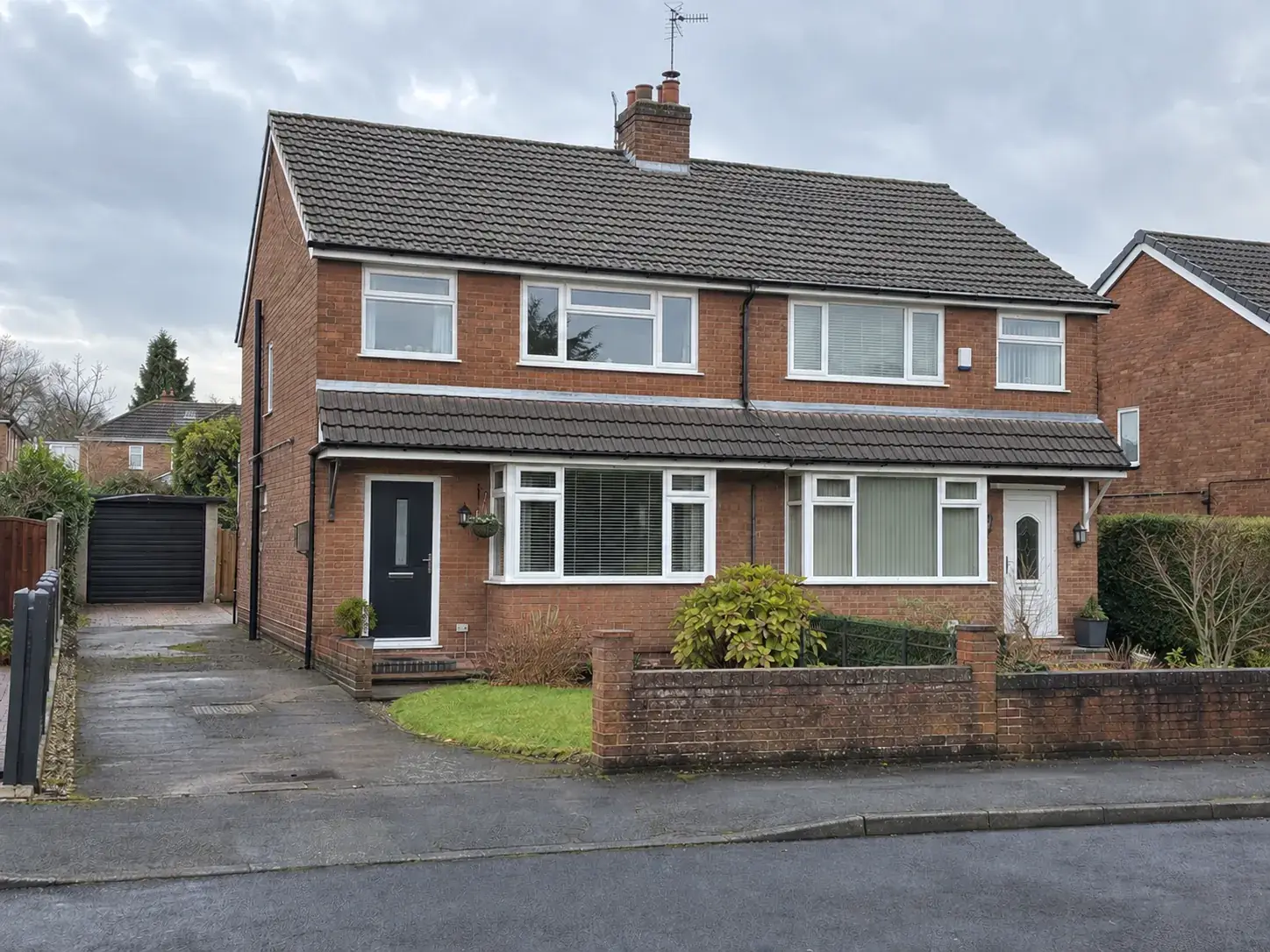 Moss-covered roof on a semi-detached house, before and after cleaning, after